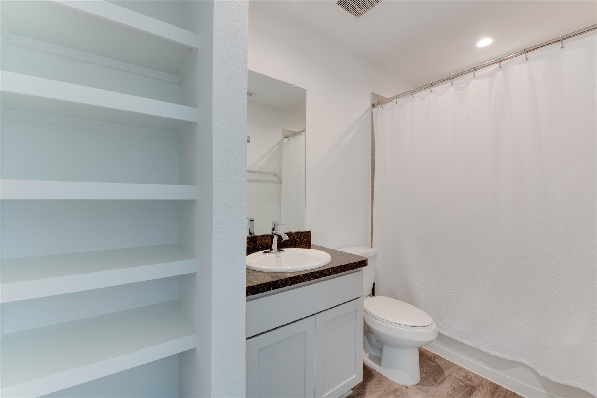 5339 Tuscany Hills Lane Spring, TX 77373 - Photo 25 of 28 a bathroom with a granite countertop sink vanity mirror and toilet