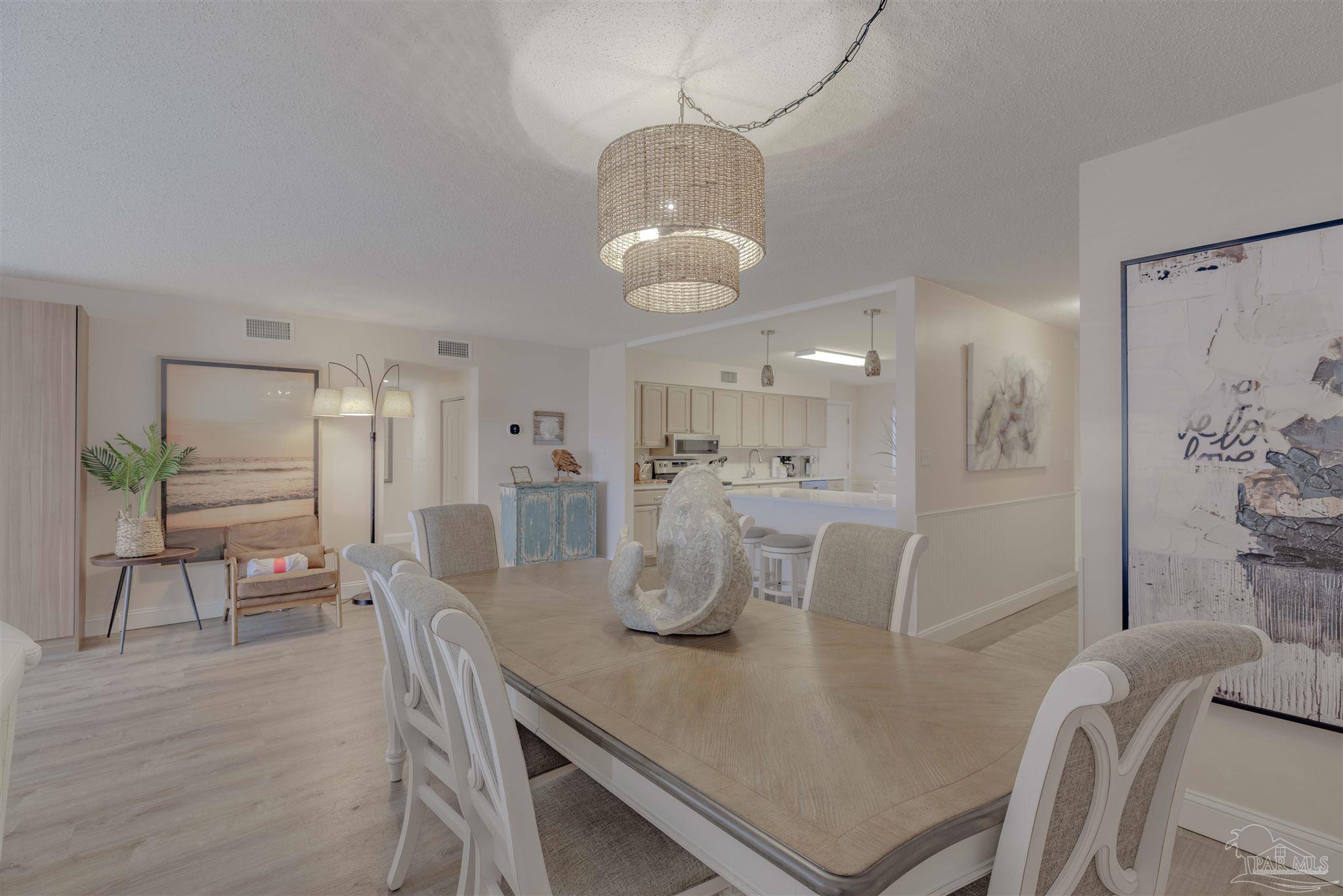 a dining room with furniture and wooden floor