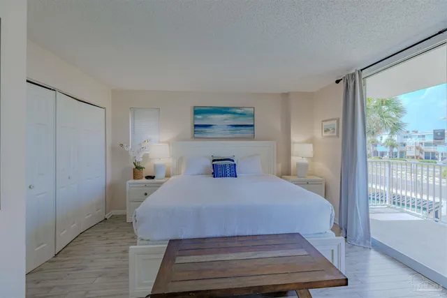 a bedroom with a bed and a large window