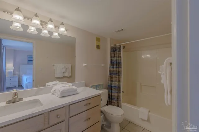 a bathroom with a shower sink vanity mirror and toilet