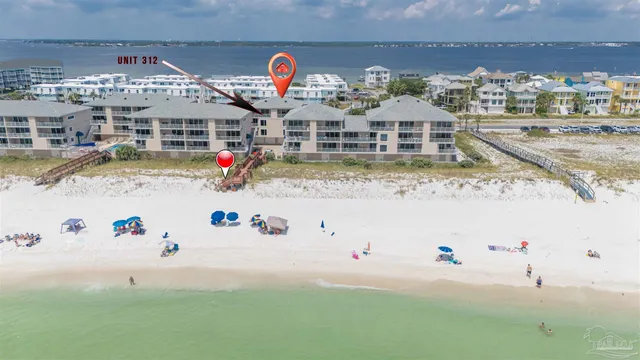 a front view of a house with garden and trees