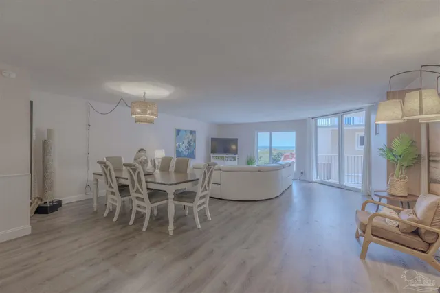 a living room with furniture wooden floor and a chandelier