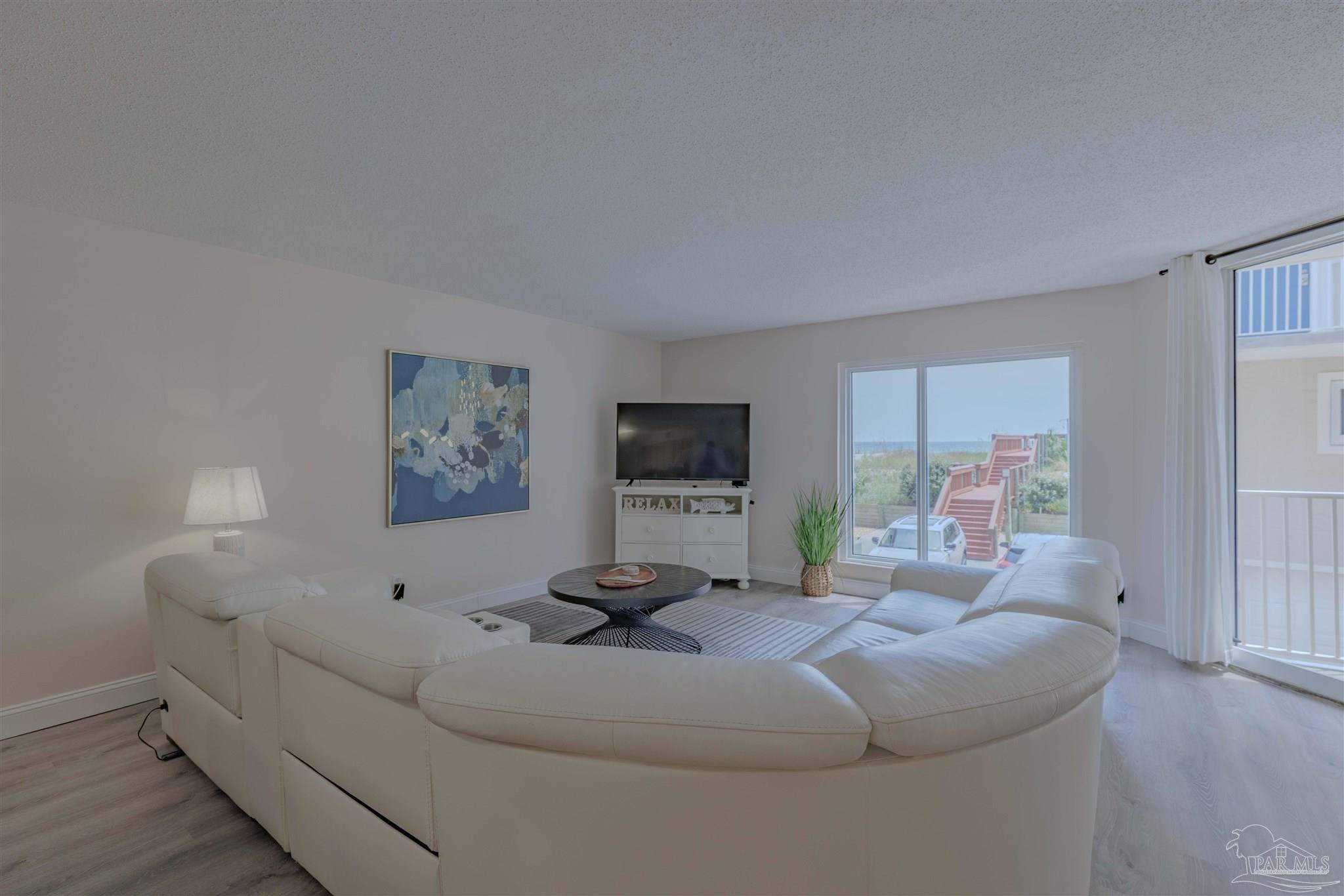 1111 Fort Pickens Road, Unit 312 Pensacola Beach, FL 32561 - Photo 6 of 40 a living room with furniture and a window