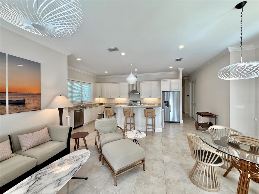 506 Cypress Road Vero Beach, FL 32963 - Photo 13 of 35 a living room with furniture and a dining table