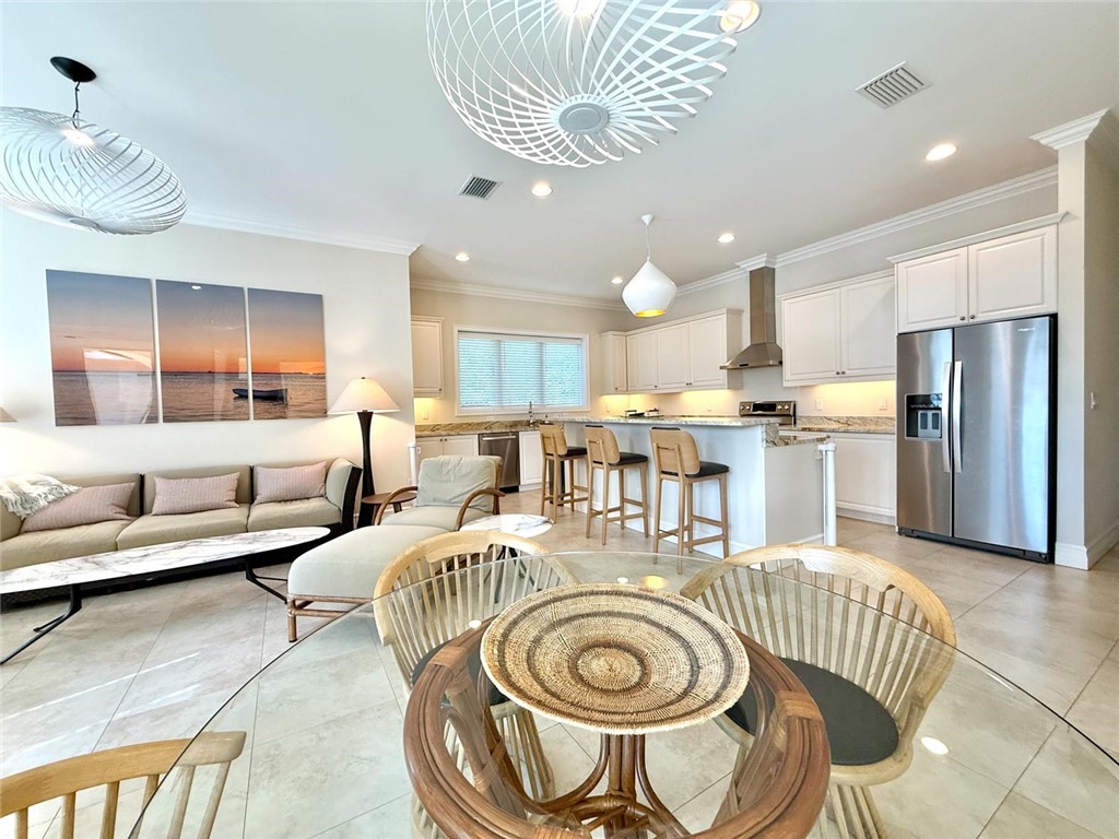 506 Cypress Road Vero Beach, FL 32963 - Photo 14 of 35 a kitchen with stainless steel appliances granite countertop a sink and a refrigerator