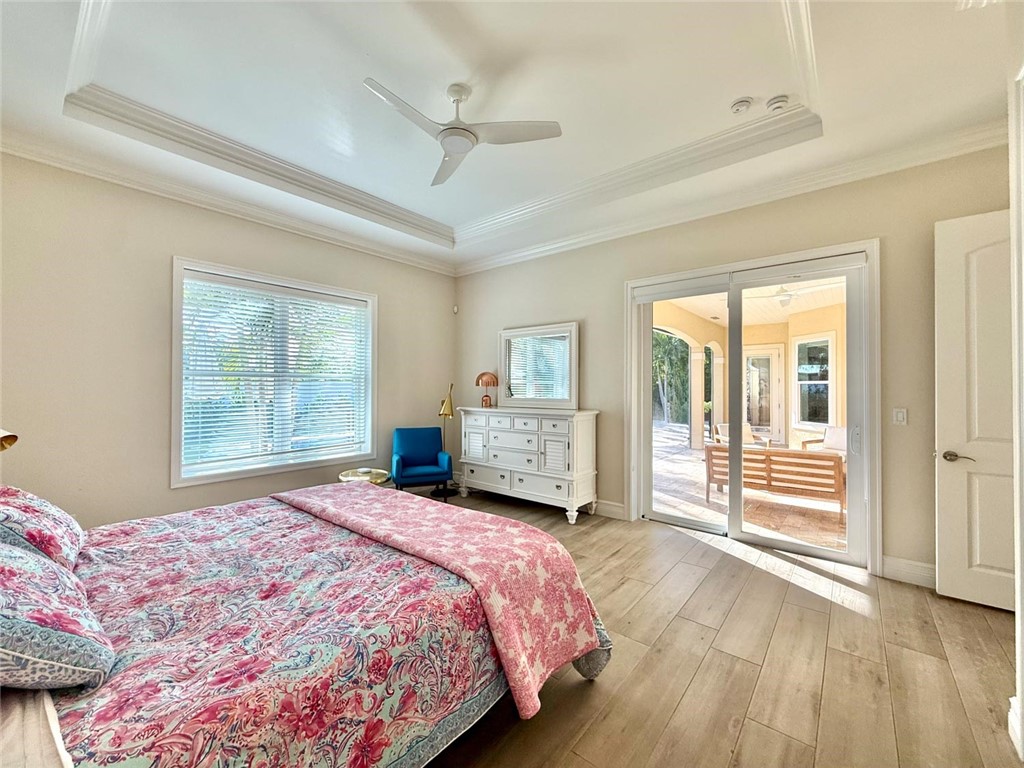 506 Cypress Road Vero Beach, FL 32963 - Photo 16 of 35 a bedroom with a large bed and a large window