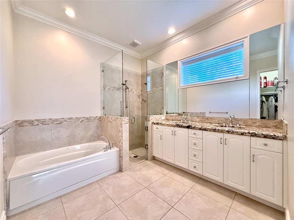 506 Cypress Road Vero Beach, FL 32963 - Photo 18 of 35 a bathroom with a granite countertop sink a toilet and bathtub
