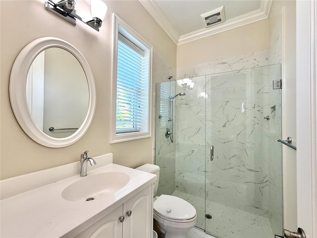 506 Cypress Road Vero Beach, FL 32963 - Photo 22 of 35 a bathroom with a sink a toilet and a mirror