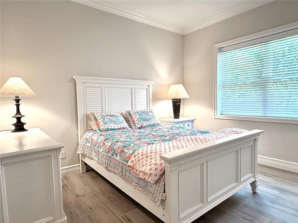 506 Cypress Road Vero Beach, FL 32963 - Photo 23 of 35 a bedroom with a bed and a lamp
