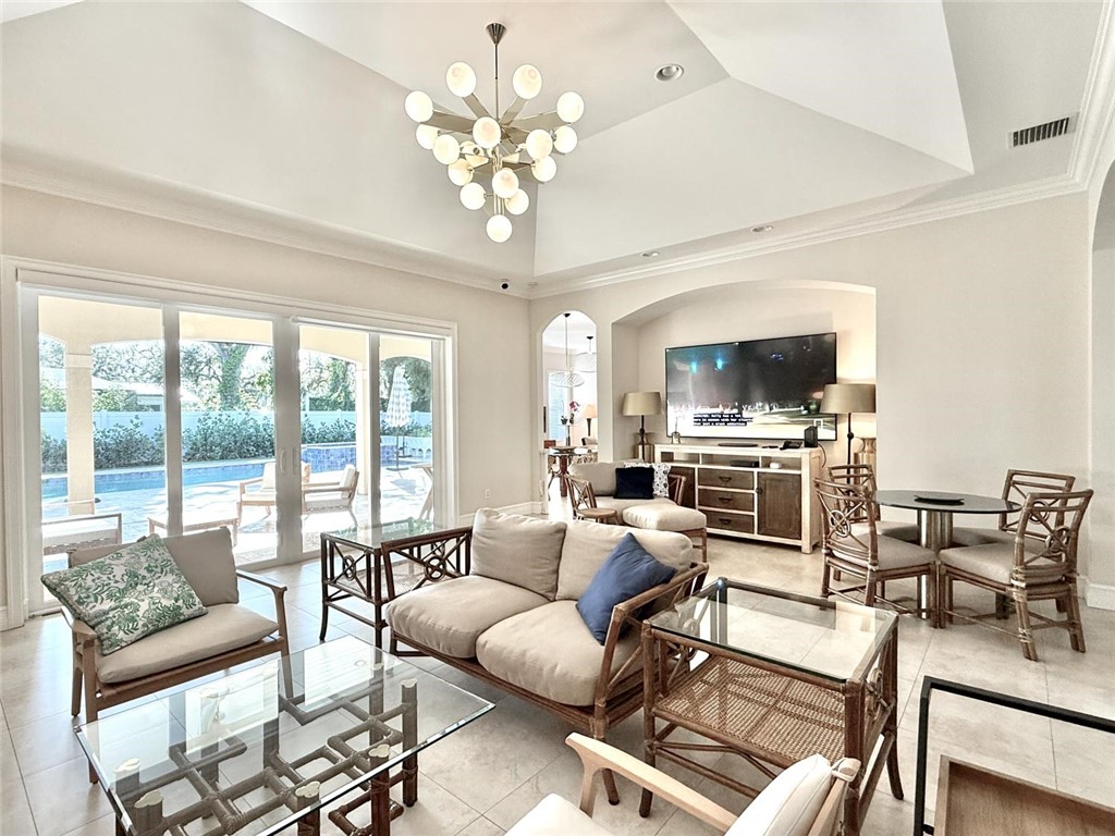 506 Cypress Road Vero Beach, FL 32963 - Photo 4 of 35 a living room with furniture or chandelier and a dining table