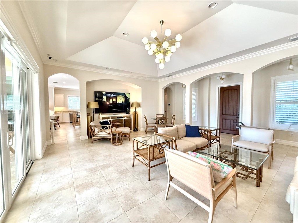 506 Cypress Road Vero Beach, FL 32963 - Photo 5 of 35 a living room with fireplace furniture and a chandelier