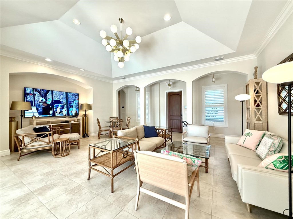 506 Cypress Road Vero Beach, FL 32963 - Photo 6 of 35 a living room with furniture a chandelier and a flat screen tv