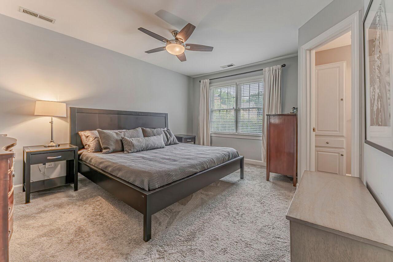 106 Hatfield Lane Raleigh, NC 27603 - Photo 19 of 29 a bedroom with a bed and a chandelier