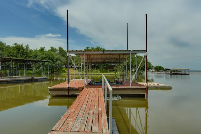 a view of house with swimming pool and outdoor seating