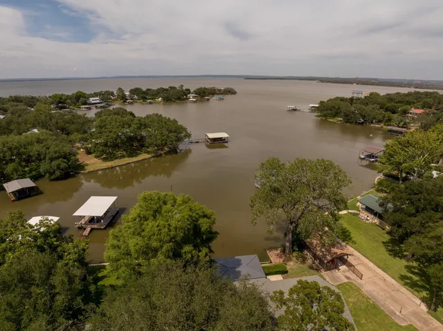 a terrace with outdoor seating and lake view