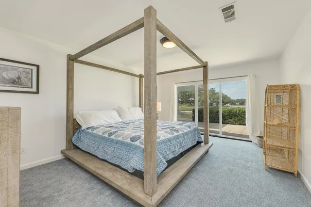 a bed room with a bed and a large window