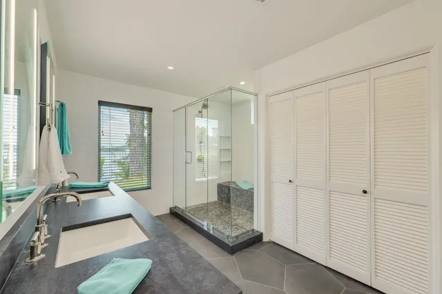 a living room with couch cabinet and a large window