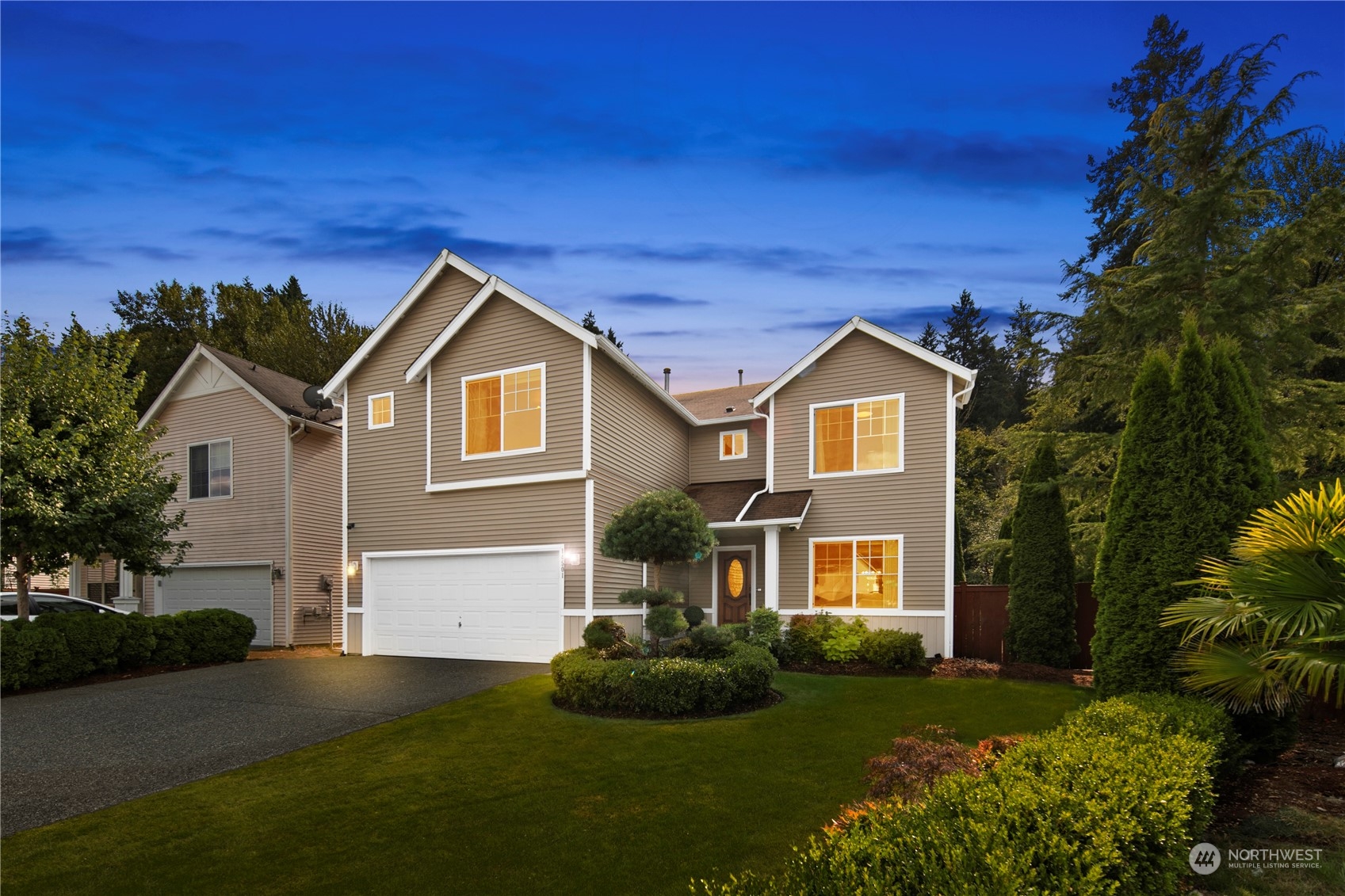 a front view of a house with a yard and garage