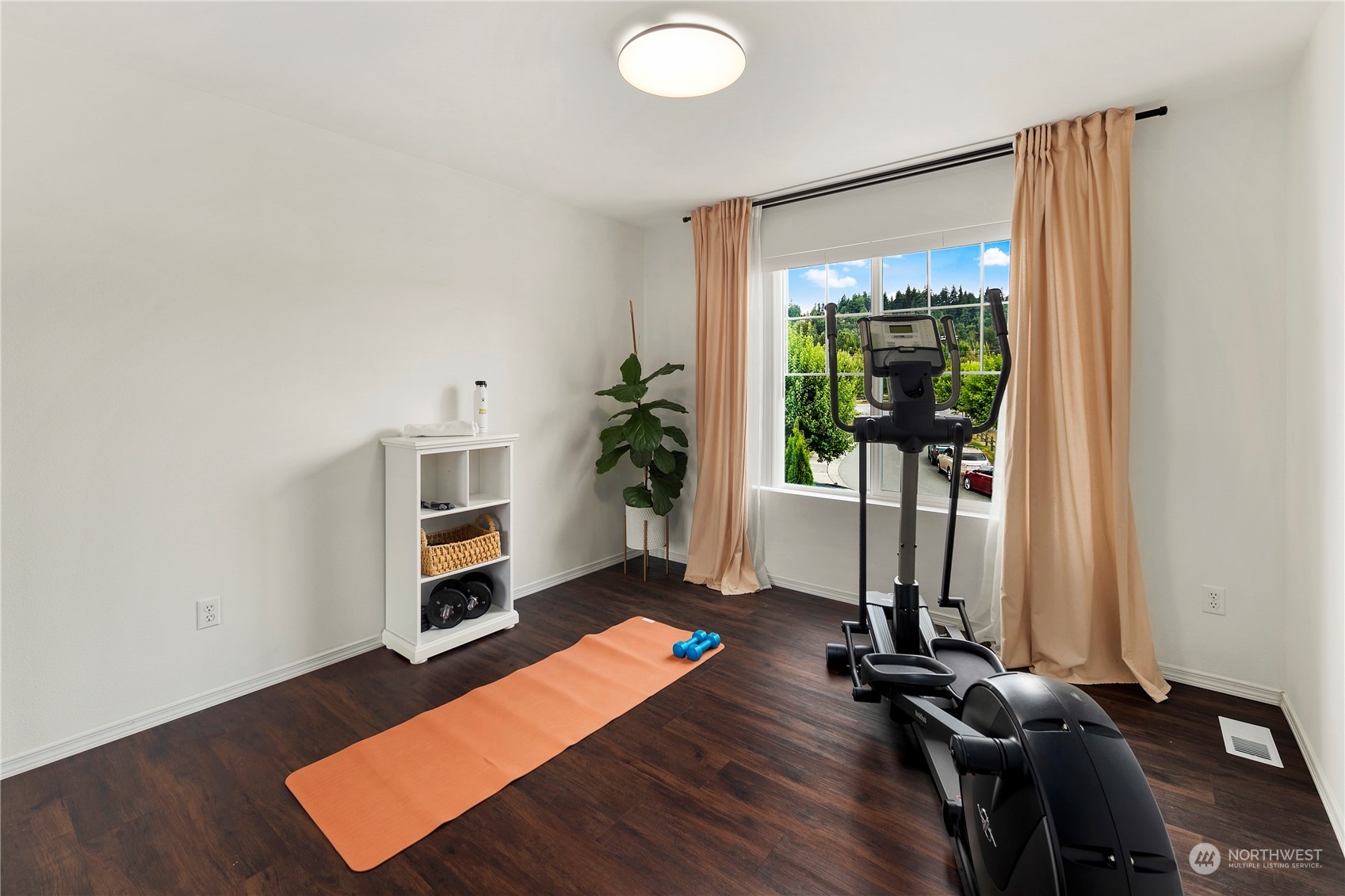 14501 Southeast 154th Street Renton, WA 98058 - Photo 24 of 36 a view of a room with gym equipment and a large window