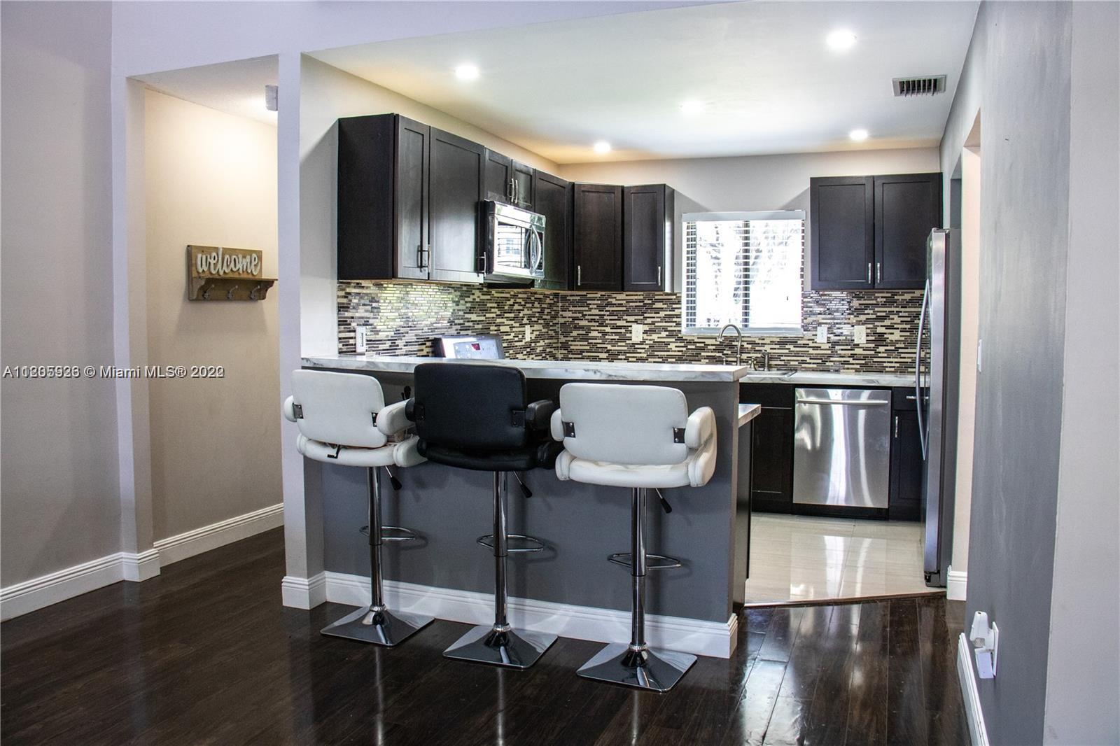9300 Southwest 132nd Street, Unit 9300 Miami, FL 33176 - Photo 3 of 13 a kitchen with a table and chairs