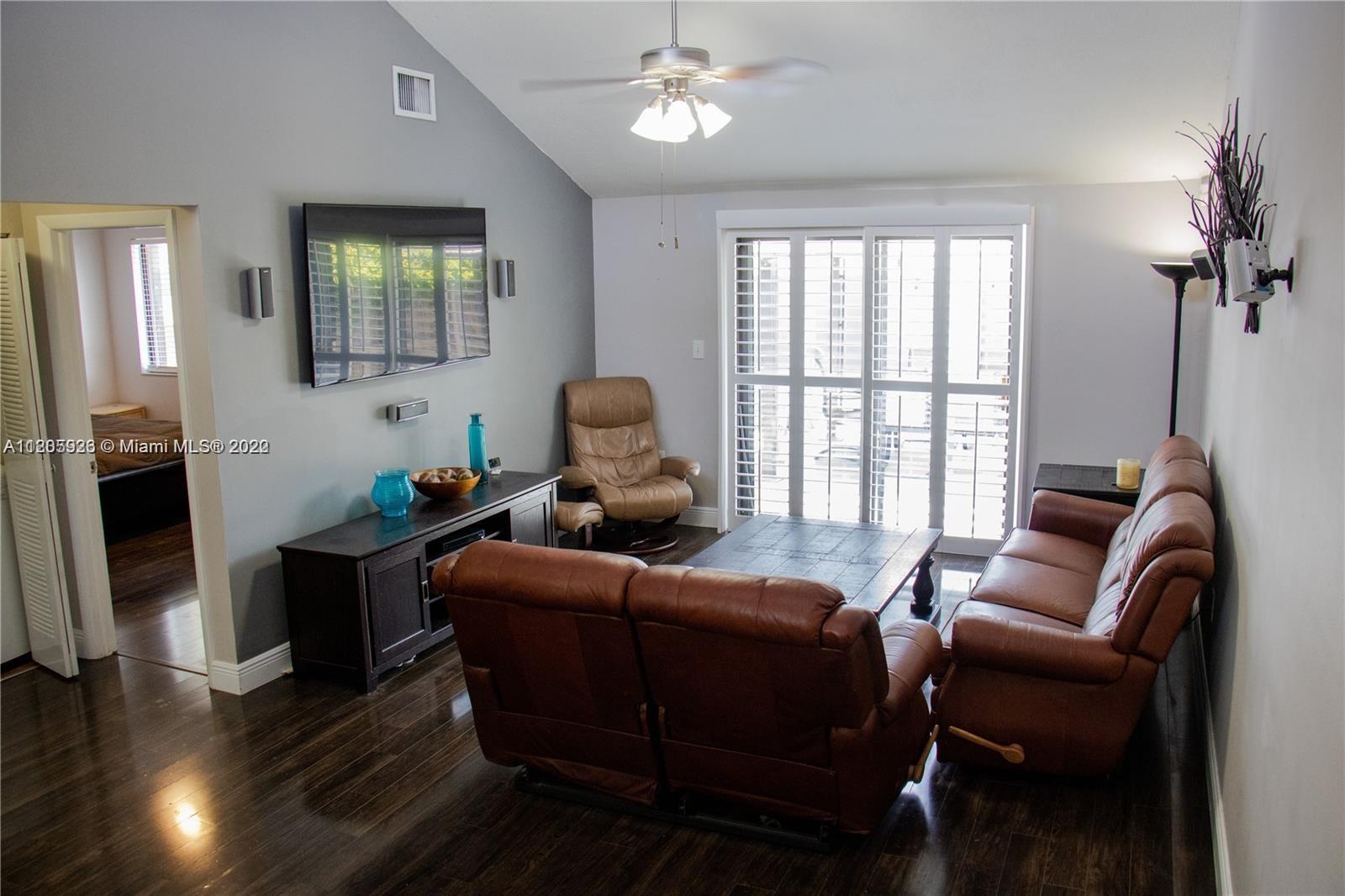 9300 Southwest 132nd Street, Unit 9300 Miami, FL 33176 - Photo 6 of 13 a living room with furniture a ceiling fan a rug and a window