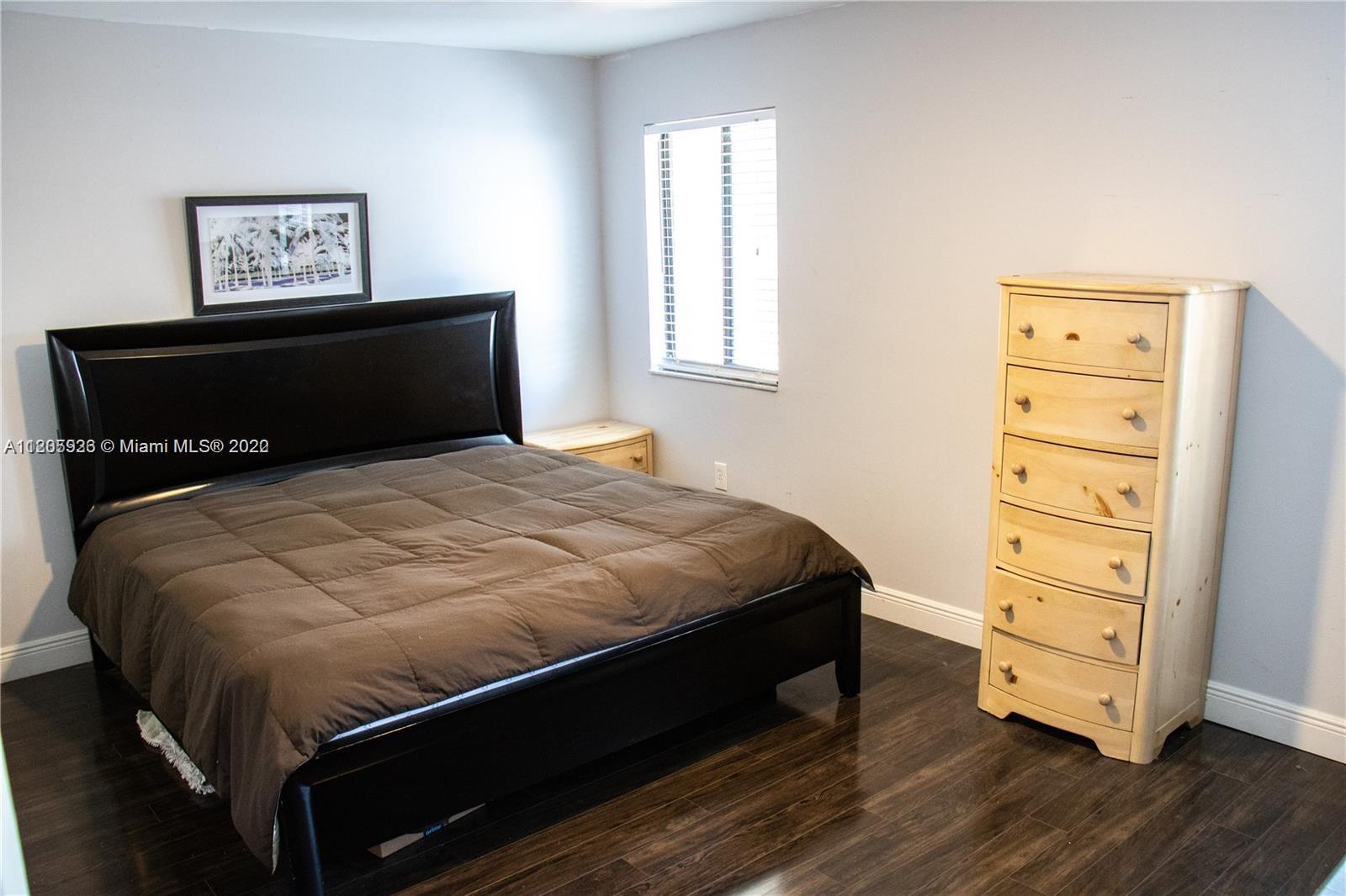 9300 Southwest 132nd Street, Unit 9300 Miami, FL 33176 - Photo 8 of 13 a bedroom with a bed and a dresser