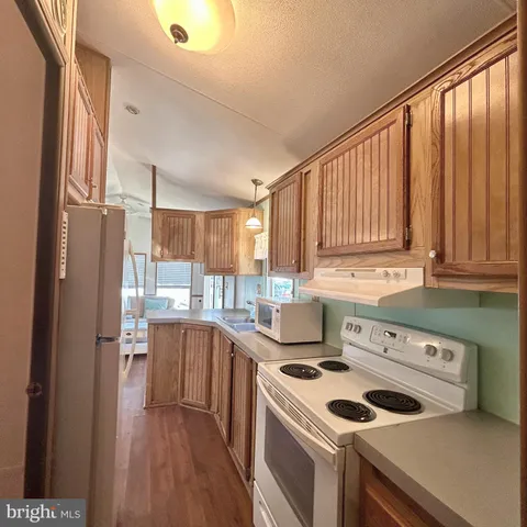 a kitchen with a stove a sink and a refrigerator