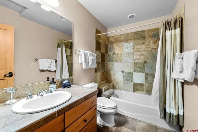 a bathroom with a sink a mirror and a shower