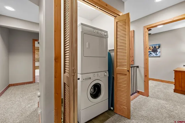 a bedroom with bed and a chandelier