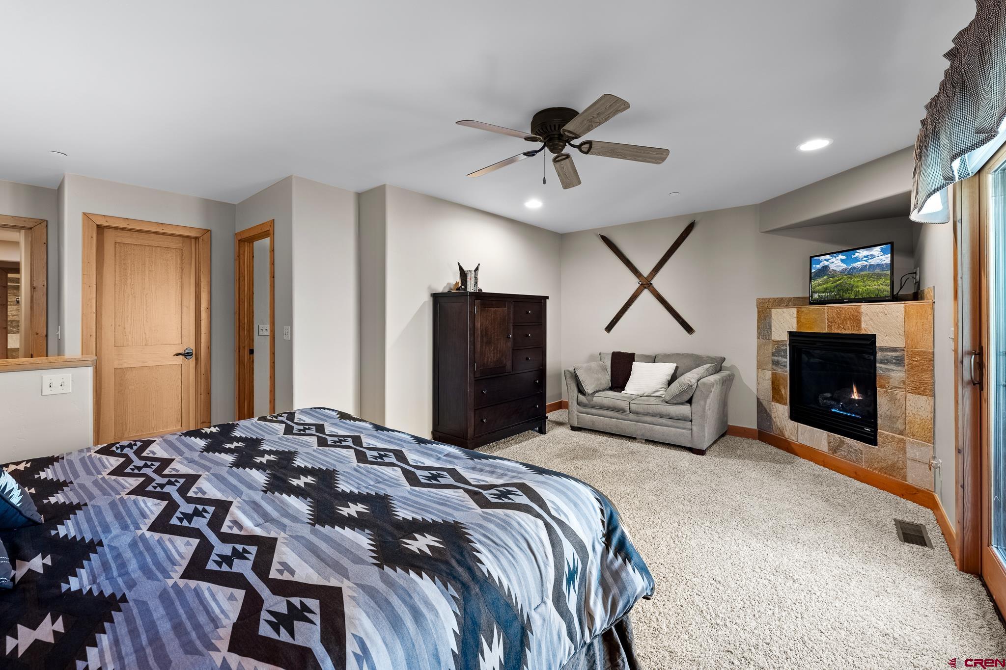 67 Travertine Trail Durango, CO 81301 - Photo 25 of 34 a bedroom with a bed and a fireplace
