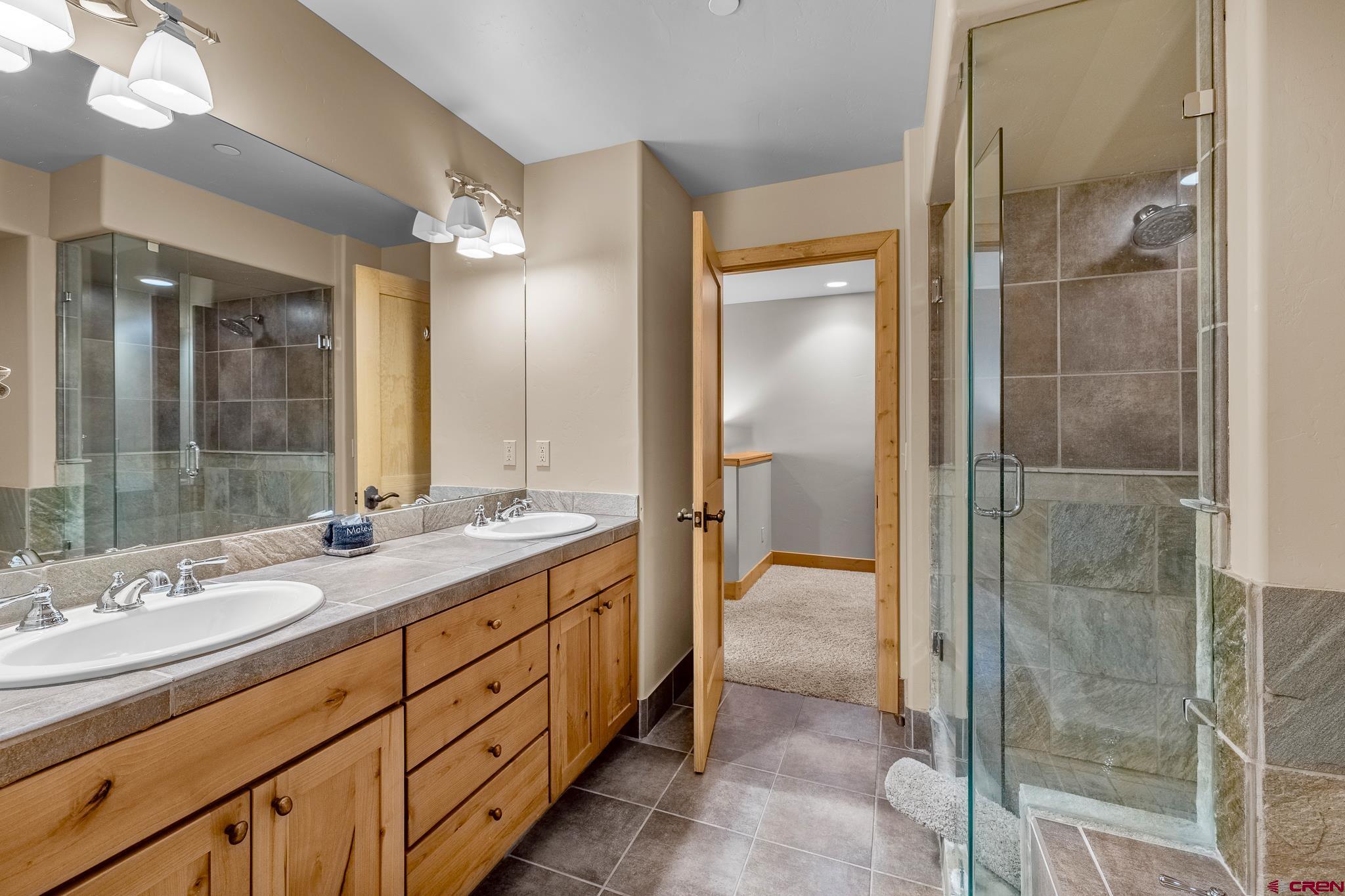 67 Travertine Trail Durango, CO 81301 - Photo 26 of 34 a bathroom with a double vanity sink mirror and shower