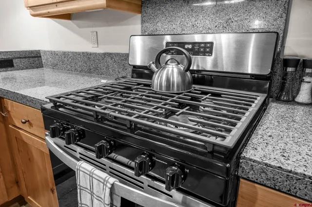 a stove sitting inside of a kitchen