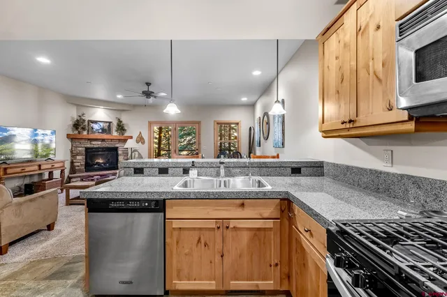 a kitchen with stainless steel appliances granite countertop a sink and cabinets