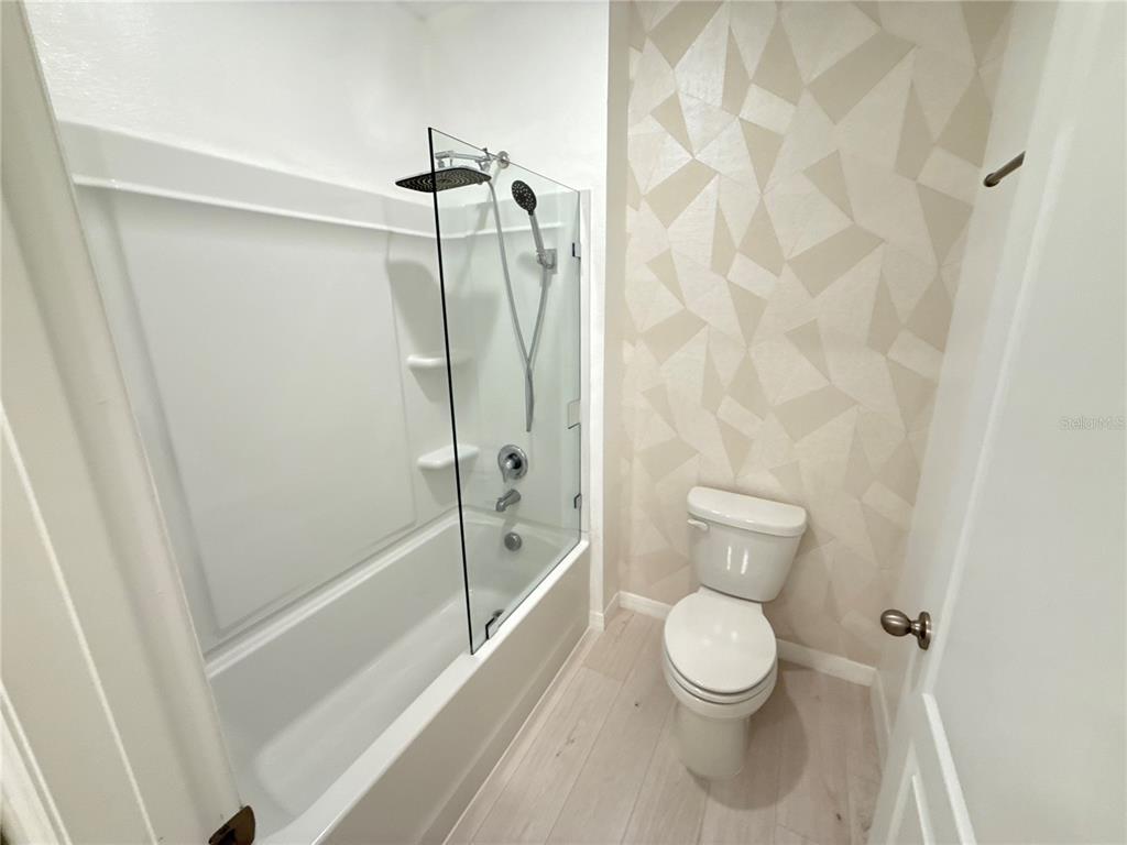 2731 House Finch Road Harmony, FL 34773 - Photo 39 of 95 a white toilet sitting next to a bath tub