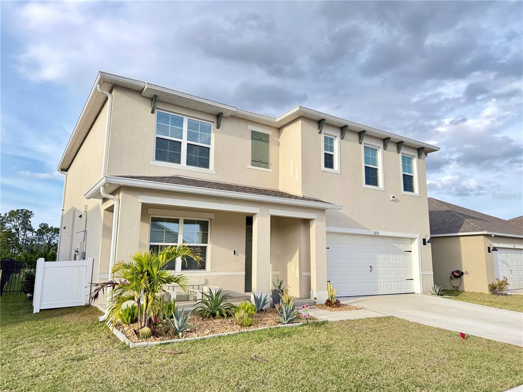 2731 House Finch Road Harmony, FL 34773 - Photo 4 of 95 a front view of a house with a yard