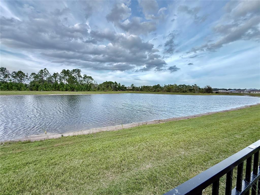 2731 House Finch Road Harmony, FL 34773 - Photo 61 of 95 a view of a lake with houses in the back