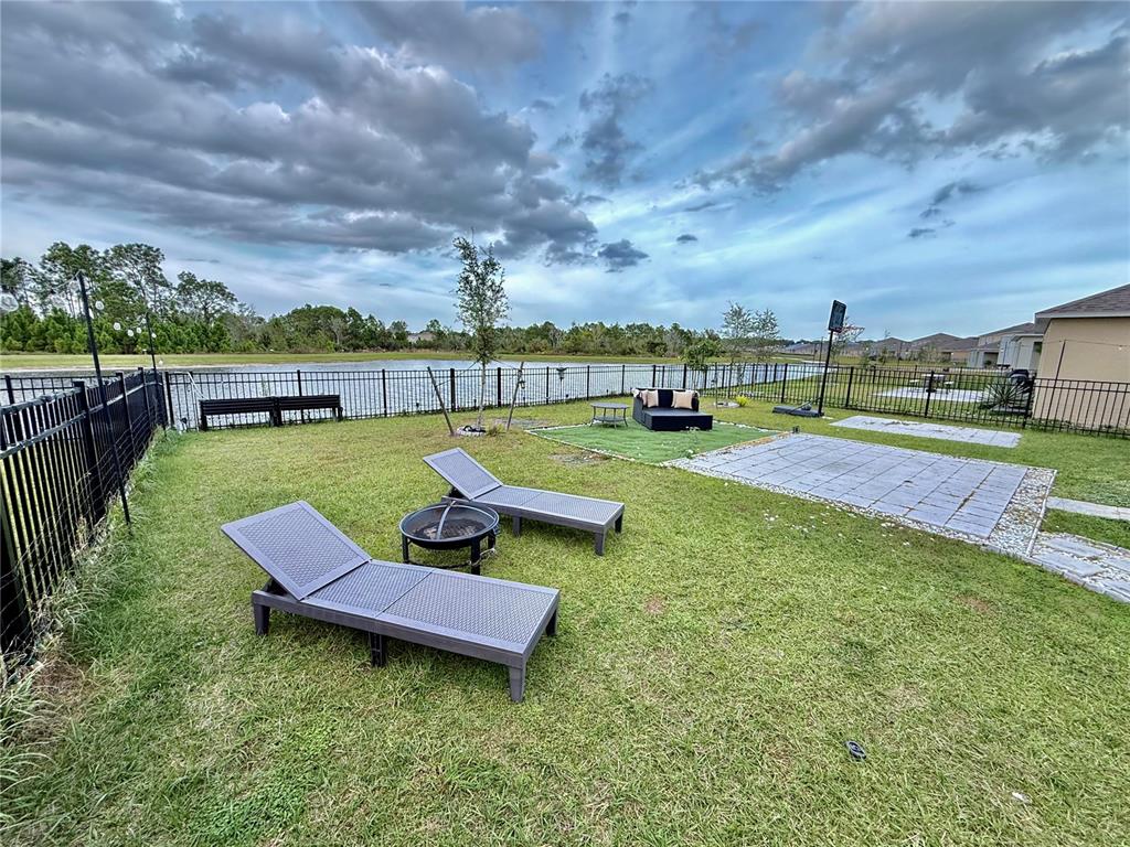 2731 House Finch Road Harmony, FL 34773 - Photo 62 of 95 a view of a swimming pool and lounge chairs in back yard of the house
