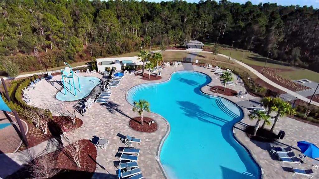 2731 House Finch Road Harmony, FL 34773 - Photo 69 of 95 an aerial view of a swimming pool patio and outdoor seating