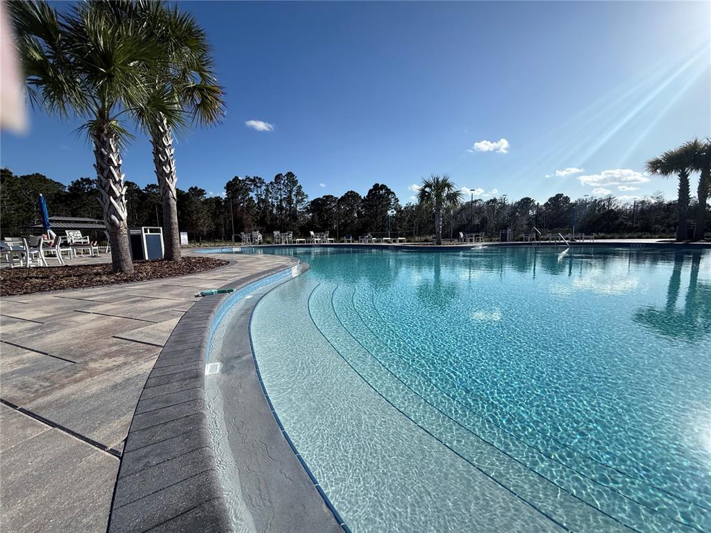 2731 House Finch Road Harmony, FL 34773 - Photo 86 of 95 a view of a lake with a table and chairs