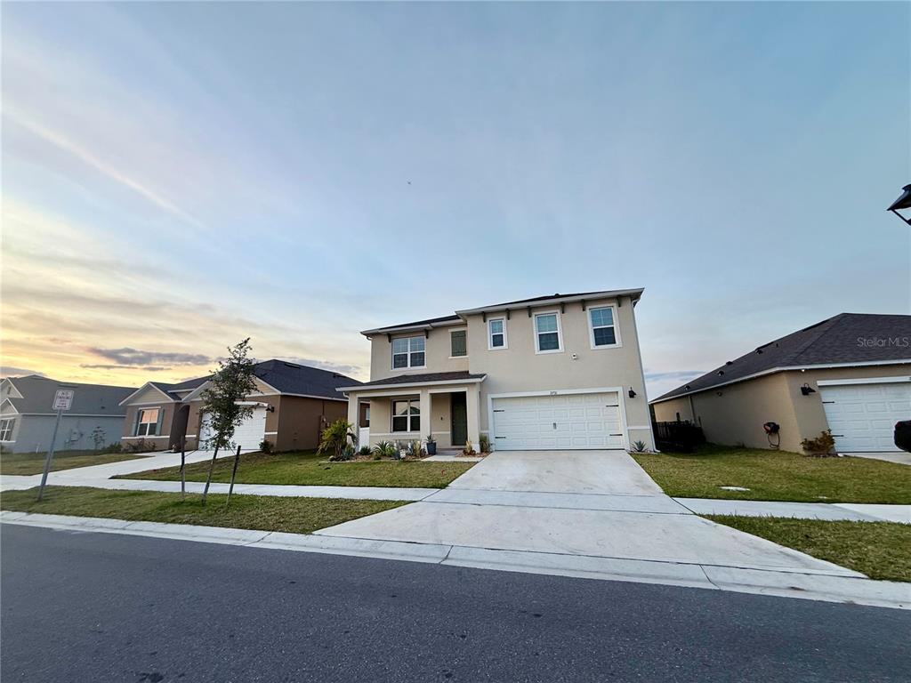 2731 House Finch Road Harmony, FL 34773 - Photo 10 of 95 a front view of a house with a yard