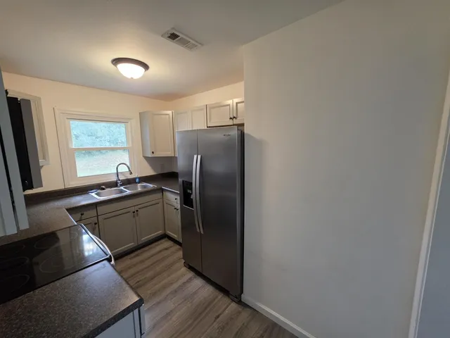 a kitchen with a refrigerator and a sink