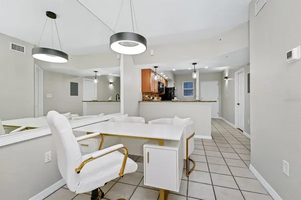 a large kitchen with a table and chairs