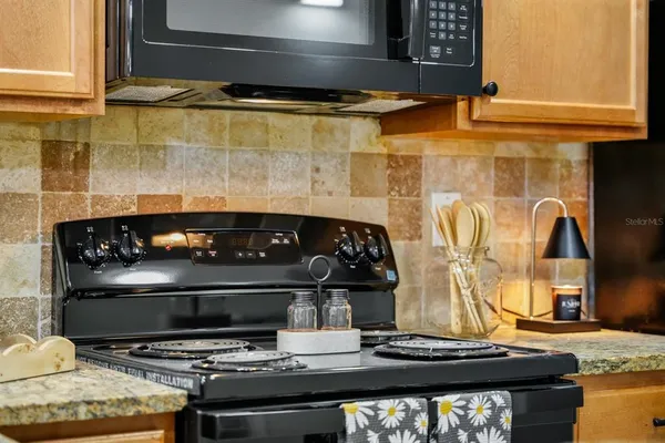 a kitchen with a stove and a microwave