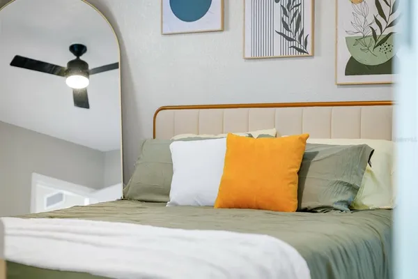 a bedroom with a bed and wooden floor