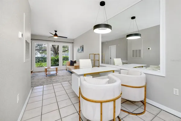 a very nice looking dining room with a large window and dining table