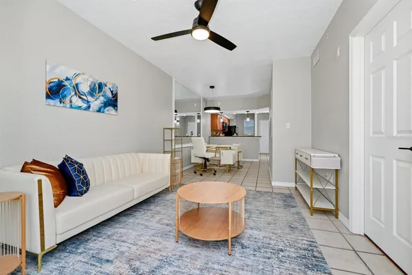 a living room with furniture and a chandelier