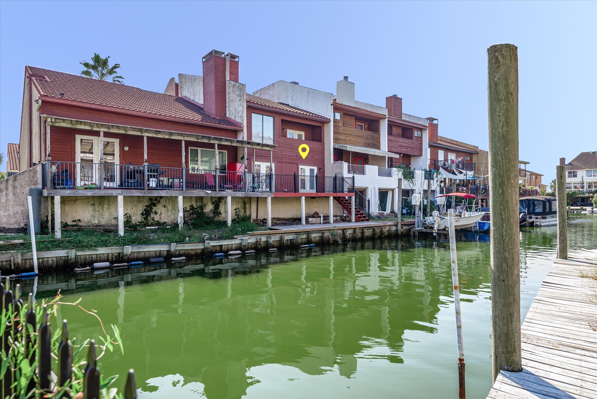 18 Antilles Lane Nassau Bay, TX 77058 - Photo 27 of 44 a view of a lake with a building and a yard in the back