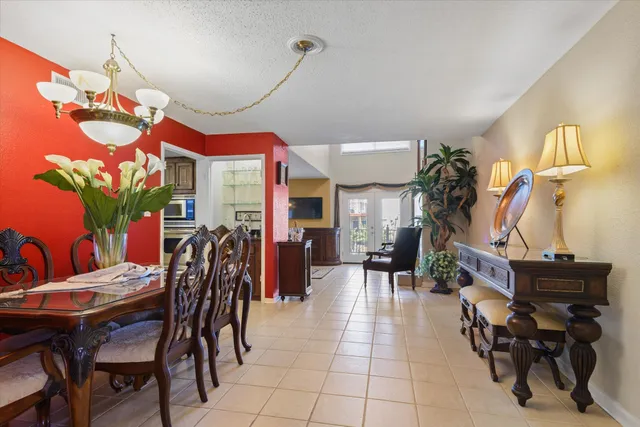 a view of a dining room with furniture and chandelier