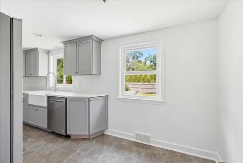 a kitchen with stainless steel appliances granite countertop a sink and a stove top oven