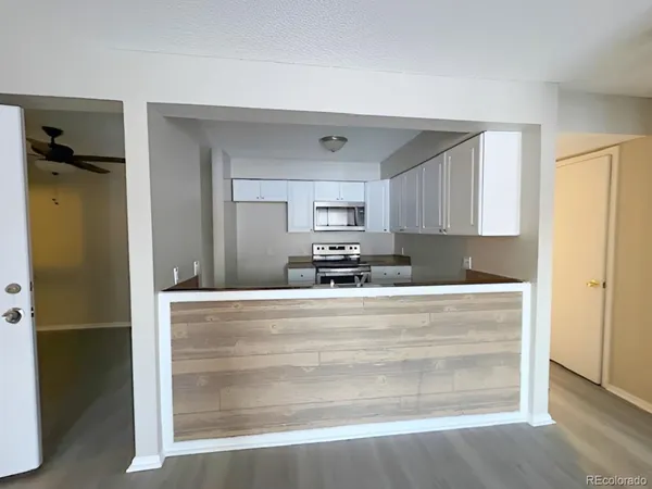 a kitchen with stainless steel appliances granite countertop a sink a stove and a refrigerator